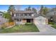 Traditional two-story home with a well-maintained lawn, brick accents, and an attached two-car garage at 8132 Lodgepole Trl, Lone Tree, CO 80124