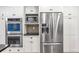 The kitchen has a stainless steel refrigerator, microwave and double ovens at 8132 Lodgepole Trl, Lone Tree, CO 80124