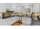 Bright kitchen with white cabinetry, black counters, and stainless steel appliances at 8132 Lodgepole Trl, Lone Tree, CO 80124