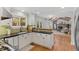 Bright kitchen featuring white cabinetry, black countertops, and an open view into the living room at 8132 Lodgepole Trl, Lone Tree, CO 80124