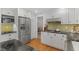 Kitchen with stainless steel appliances and white cabinetry at 8132 Lodgepole Trl, Lone Tree, CO 80124
