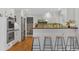 Modern kitchen with white cabinetry, stainless steel appliances, and a breakfast bar with seating at 8132 Lodgepole Trl, Lone Tree, CO 80124