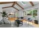 Bright living room with skylights, exposed beams, and an open layout connecting to the kitchen at 8132 Lodgepole Trl, Lone Tree, CO 80124