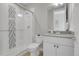 Modern bathroom with a walk-in shower and white vanity at 6025 Ames St # A, Arvada, CO 80003
