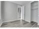 Simple bedroom with gray walls and gray laminate flooring at 6025 Ames St # A, Arvada, CO 80003