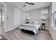 Spacious bedroom with wood-look floors, ceiling fan, and ample natural light at 6025 Ames St # A, Arvada, CO 80003