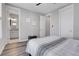 Bright bedroom with gray walls and access to bathroom at 6025 Ames St # A, Arvada, CO 80003