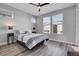 Bright bedroom with wood-look floors, ceiling fan, and large windows at 6025 Ames St # A, Arvada, CO 80003