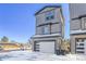 Modern two-story home with attached garage and snowy yard at 6025 Ames St # A, Arvada, CO 80003