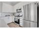 Modern kitchen with stainless steel appliances and white cabinets at 6025 Ames St # A, Arvada, CO 80003