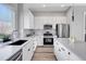 Modern kitchen with stainless steel appliances and an island at 6025 Ames St # A, Arvada, CO 80003