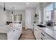 Modern kitchen with a large island and white cabinets at 6025 Ames St # A, Arvada, CO 80003