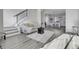 Open living room with modern stairs, and kitchen view at 6025 Ames St # A, Arvada, CO 80003
