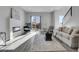Spacious living room with fireplace, large windows and gray flooring at 6025 Ames St # A, Arvada, CO 80003