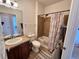 Cozy bathroom showcasing a shower-tub combo with stylish tile and vanity at 2675 S Danube Way # 302, Aurora, CO 80013