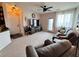 Spacious living room featuring neutral carpet, a ceiling fan, and balcony access at 2675 S Danube Way # 302, Aurora, CO 80013