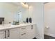Modern bathroom featuring double sinks, bright vanity, and a mirror at 4100 E Iliff Ave # 4, Denver, CO 80222