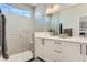 Modern bathroom featuring double sinks, bright vanity, and glass shower at 4100 E Iliff Ave # 4, Denver, CO 80222