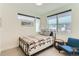 Cozy bedroom with a comfortable bed, a side chair, and large windows at 4100 E Iliff Ave # 4, Denver, CO 80222
