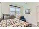 Bedroom features neutral walls, a comfortable bed, and a side chair at 4100 E Iliff Ave # 4, Denver, CO 80222