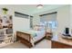 Bedroom featuring a bright queen bed, side table and shelving unit at 4100 E Iliff Ave # 4, Denver, CO 80222