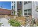 Charming townhome exterior featuring a private fenced front yard with garden and patio at 4100 E Iliff Ave # 4, Denver, CO 80222