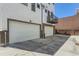 Exterior view of garage with two doors, with room for parking in front and an upper level balcony at 4100 E Iliff Ave # 4, Denver, CO 80222