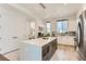 Bright kitchen features a large island with microwave, modern appliances and hardwood floors at 4100 E Iliff Ave # 4, Denver, CO 80222