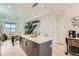 Open kitchen with a large island, modern pendant lighting, and seamless access to the living area at 4100 E Iliff Ave # 4, Denver, CO 80222