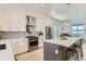 Bright, modern kitchen with stainless steel appliances, white cabinetry, and a large center island at 4100 E Iliff Ave # 4, Denver, CO 80222