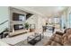 Open-concept living room with sleek fireplace, modern decor, and adjoining kitchen area at 4100 E Iliff Ave # 4, Denver, CO 80222