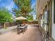 Backyard featuring a patio with an umbrella-covered dining set and a playhouse at 461 Nome St, Aurora, CO 80010