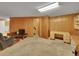 Spacious basement with wood paneled walls, carpeting, and vintage desk at 461 Nome St, Aurora, CO 80010