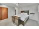 Bedroom with ceiling fan, neutral carpet, dark wood furniture, and a large bed with white bedding at 461 Nome St, Aurora, CO 80010