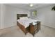 Spacious bedroom featuring neutral walls, carpet and ceiling fan, with dark wood furniture and a sunny window at 461 Nome St, Aurora, CO 80010