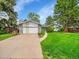 Charming single Gathering home with stone accents, a two-car garage, and a well-manicured front yard at 461 Nome St, Aurora, CO 80010