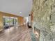 Open-concept living room featuring a stone fireplace and wood floors at 461 Nome St, Aurora, CO 80010