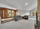 Spacious living room featuring plush carpeting, comfortable seating, and large windows for natural light at 461 Nome St, Aurora, CO 80010
