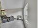 Bright living room with neutral tones, comfortable seating, and plenty of natural light from large windows at 461 Nome St, Aurora, CO 80010