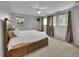 Spacious main bedroom with a large bed, a ceiling fan, and windows at 461 Nome St, Aurora, CO 80010