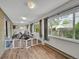 Well-lit sunroom with wood flooring and plenty of windows providing serene views of the outdoors at 461 Nome St, Aurora, CO 80010