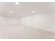 Expansive basement area with neutral carpet and recessed lighting, ready for customization at 2257 S Lowell Blvd, Denver, CO 80219