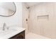 Updated bathroom features a modern sink, mirror, and a beautiful tiled shower with a built-in niche at 2257 S Lowell Blvd, Denver, CO 80219