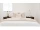 Bright bedroom showcasing a cozy bed with soft bedding and a bedside table with a lamp at 2257 S Lowell Blvd, Denver, CO 80219