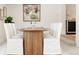 Dining room features a round wood table and white-covered chairs at 2257 S Lowell Blvd, Denver, CO 80219