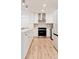 Well-lit kitchen featuring sleek cabinetry, stainless steel appliances, and hardwood flooring at 2257 S Lowell Blvd, Denver, CO 80219