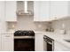 Stylish kitchen equipped with modern appliances, white cabinetry, and ample counter space at 2257 S Lowell Blvd, Denver, CO 80219