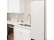 Close-up of kitchen sink, countertops, and white refrigerator at 2257 S Lowell Blvd, Denver, CO 80219