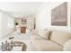Open-concept living area featuring a comfortable sofa and an adjacent dining space with natural light at 2257 S Lowell Blvd, Denver, CO 80219