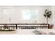 Bright living room with white sofa, large window, and decorative tree at 2257 S Lowell Blvd, Denver, CO 80219